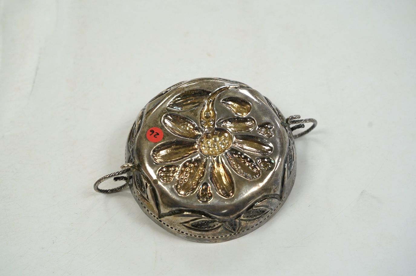 An Edwardian 17th century style Britannia standard silver porringer, by Maurice Freeman, London, circa 1905, 12cm, over handles. Condition - fair